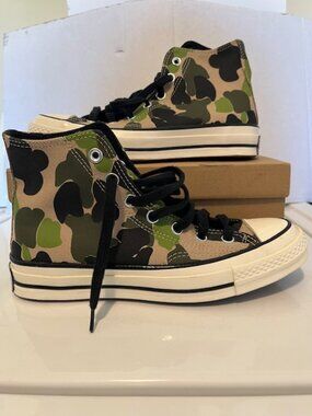 Converse camouflage high top sneakers.